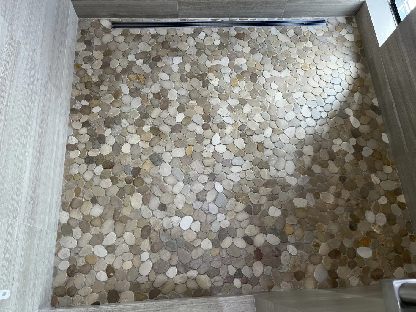 Pebble stone shower floor after professional restoration