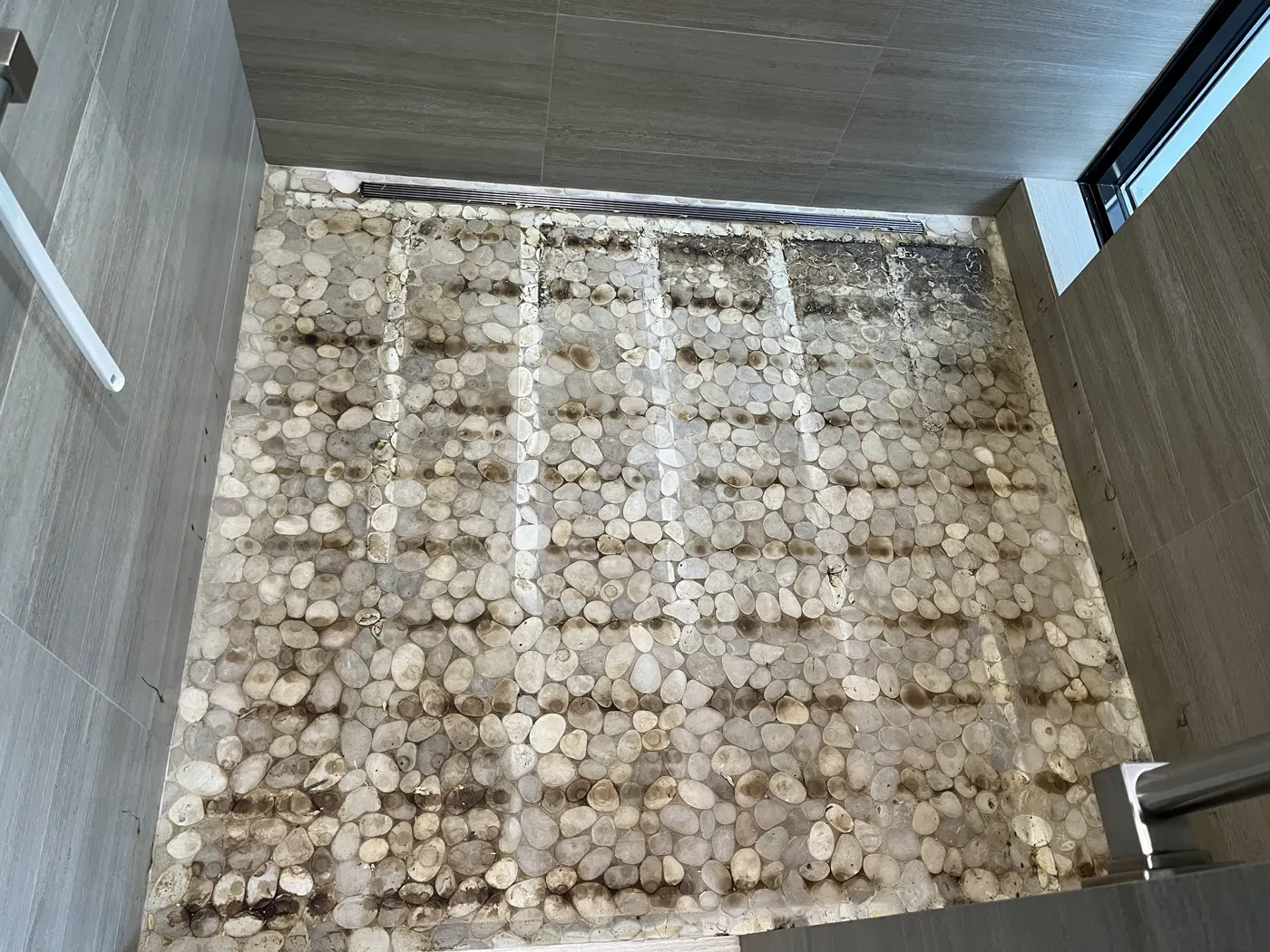 Pebble shower floor before shower restoration